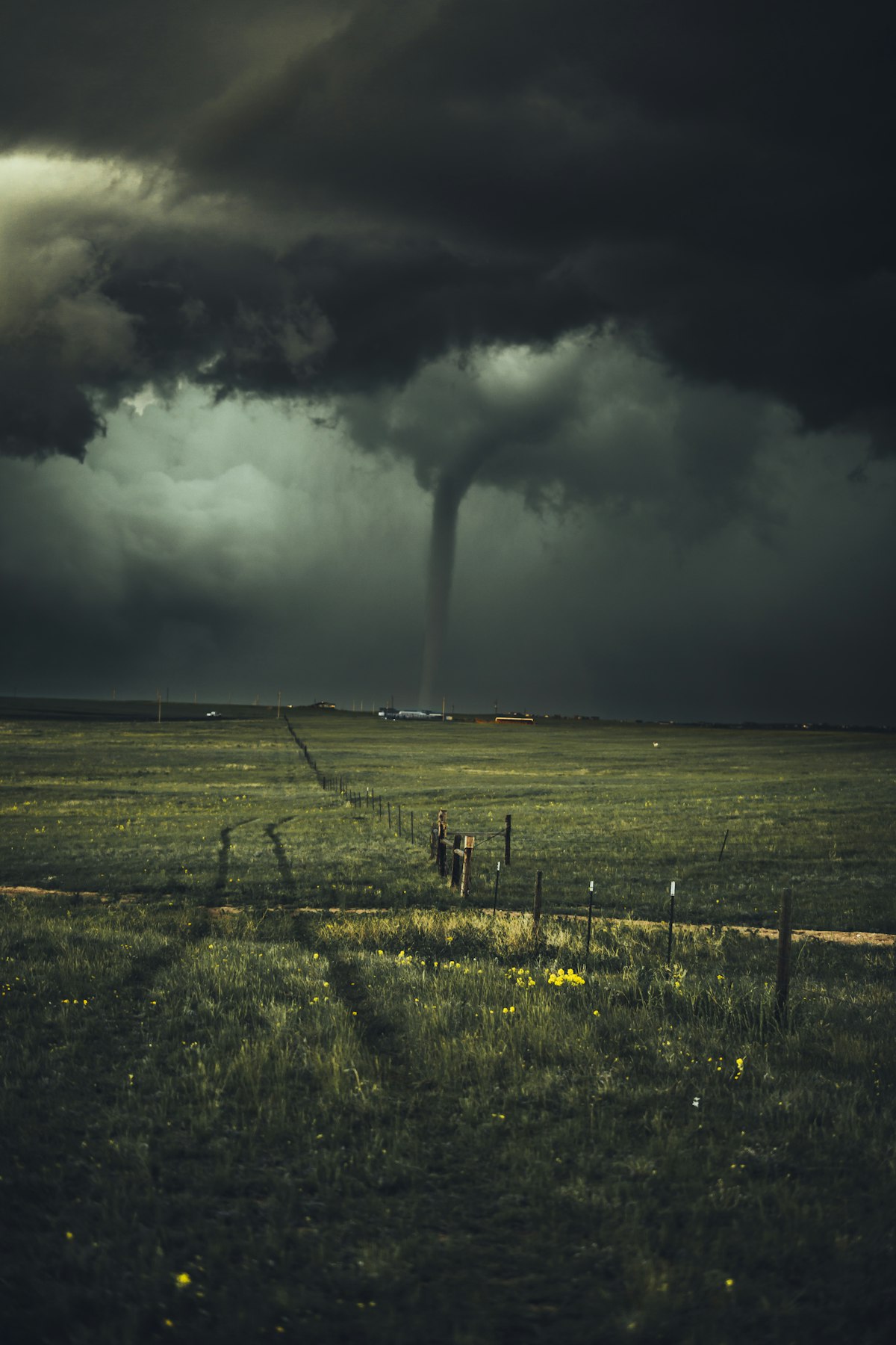 Dramatic storm clouds and weather satellite imagery over a rural landscape